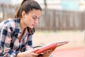 Concentrated student studying memorizing in a park