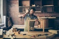 Concentrated successful knowledgeable smart bearded craftsman we