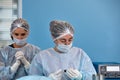 Concentrated Surgical team operating a patient in an operation theater. Royalty Free Stock Photo