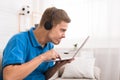 Concentrated teen boy playing video games on laptop Royalty Free Stock Photo