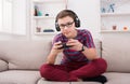 Concentrated teenage boy playing video game at home Royalty Free Stock Photo