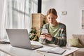 concentrated teenager girl using her smartphone