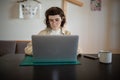 Concentrated teenager working, studying with laptop computer in comfortable conditions at home Royalty Free Stock Photo