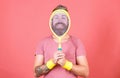 Concentrated on tennis court. Athlete hipster hold tennis racket in hand red background. Man bearded hipster wear sport Royalty Free Stock Photo