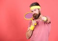 Concentrated on tennis court. Athlete hipster hold tennis racket in hand red background. Tennis sport and entertainment Royalty Free Stock Photo