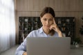 Concentrated thoughtful young business lady working on computer. Royalty Free Stock Photo