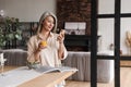 Concentrated woman chatting by phone and drinking juice