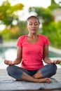 Concentrated woman with close eyes doing yoga