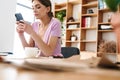 Concentrated woman designer indoors in office