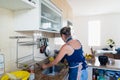 Concentrated woman is preparing proper meal in the kitchen