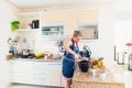 Concentrated woman is preparing proper meal in the kitchen