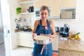 Concentrated woman is preparing proper meal in the kitchen