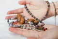 Concentrated woman wearing rosary beads. Close up Royalty Free Stock Photo