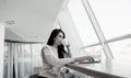 Concentrated woman working on her laptop and drinking coffee. Casual clothes concept. Brunette woman freelancer working Royalty Free Stock Photo