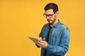 Concentrated on work. Confident young handsome man in casual working on laptop Royalty Free Stock Photo