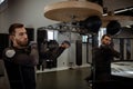 Concentrated boxer honing skills on speed bag in boxing gym Royalty Free Stock Photo