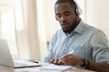 Focused black guy busy with certification training. Royalty Free Stock Photo