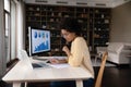 Concentrated young african american woman working with economic report. Royalty Free Stock Photo