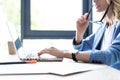 Concentrated young beautiful businesswoman working on laptop in bright modern office. Royalty Free Stock Photo