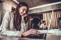 Concentrated young beautiful businesswoman working on laptop in bright modern office Royalty Free Stock Photo