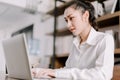 Concentrated young beautiful businesswoman working on laptop in bright modern office,Work from home concept Royalty Free Stock Photo