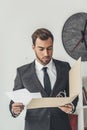 concentrated young businessman with documents folder Royalty Free Stock Photo