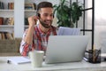 Concentrated young freelancer businessman using laptop for video conferance, working remotely online at home