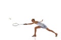 Concentrated young girl, athlete in motion with racket, playing badminton, hitting shuttlecock isolated over white Royalty Free Stock Photo