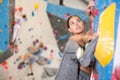 Concentrated young girl climbing on bouldering wall in gym Royalty Free Stock Photo