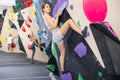 Young girl moving on bouldering wall at indoor climbing gym Royalty Free Stock Photo