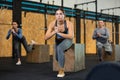 Girl performing Bulgarian split squats with plyometric box at gym