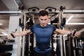 A young handsome man doing strength workout exercise in gym. Royalty Free Stock Photo