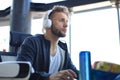 Concentrated young man in casual clothing using computer, streaming playthrough or walkthrough video Royalty Free Stock Photo