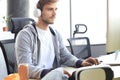 Concentrated young man in casual clothing using computer, streaming playthrough or walkthrough video Royalty Free Stock Photo
