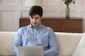 Concentrated young man freelancer working from home on laptop Royalty Free Stock Photo