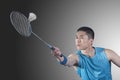 Concentrated Young man playing badminton, hitting Royalty Free Stock Photo