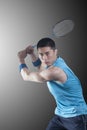Concentrated Young man playing badminton, racket raised Royalty Free Stock Photo