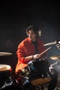 Concentrated young man playing drum set in garage Royalty Free Stock Photo