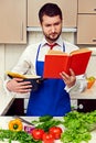 Concentrated young man reading cookbook