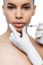 Concentrated young Negroid woman having the injection
