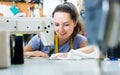 concentrated young professional female tailor using sewing machine Royalty Free Stock Photo