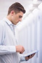 Concentrating young technician working with his tablet Royalty Free Stock Photo