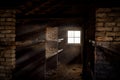 Concentration death camp dark eerie wooden bunk bed barracks with light rays shining through window. Extermination camp sleeping Royalty Free Stock Photo
