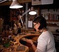 Concentration is key. An artist creating something out of wood.