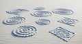 Concentric circles and geometric patterns made from smooth white stones are arranged on a textured Royalty Free Stock Photo