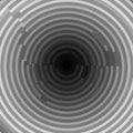 Concentric circles in varying shades of gray form a spiral pattern, creating a sense of Royalty Free Stock Photo