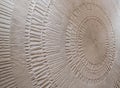 ????????? Textured sculpted wall surface with concentric circular relief patterns, hand-carved decorative plaster details Royalty Free Stock Photo