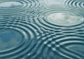 Concentric ripples form on a water surface, creating a pattern of Royalty Free Stock Photo