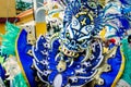 Closeup human in pied mask and costume poses for photo at dominican carnival