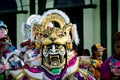 Closeup person in large golden lion mask poses for photo at dominican carnival